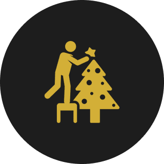 Person decorating a Christmas tree icon.
